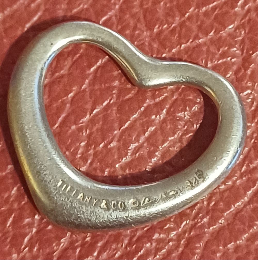 Tiffany & Co. Silver Heart Pendant on Red Background